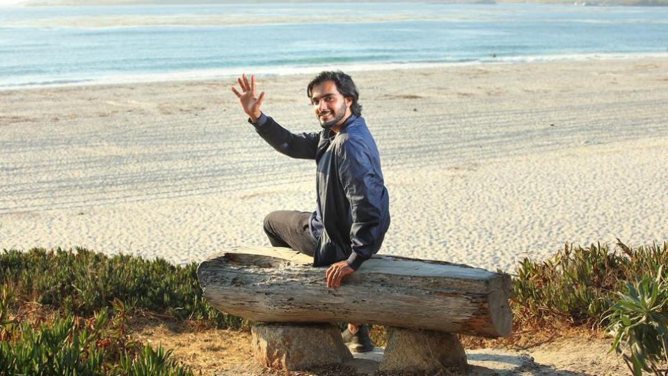 Photo: Student waving on the beach