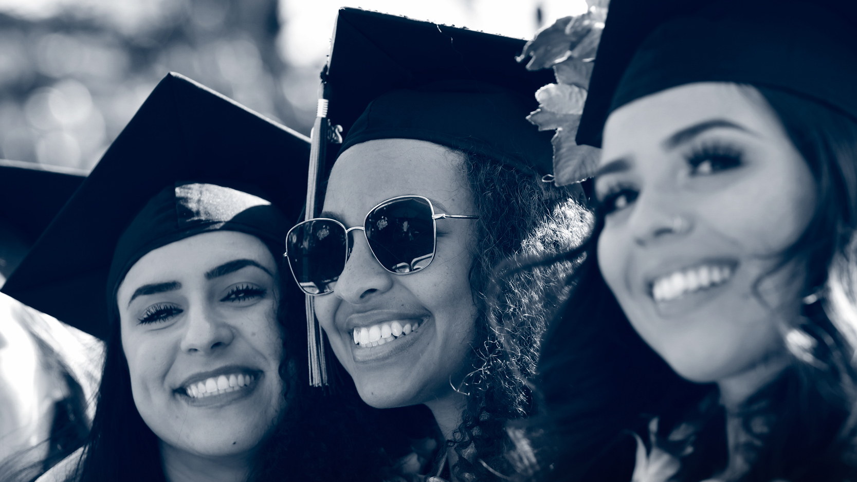 Graduates smiling during commencement