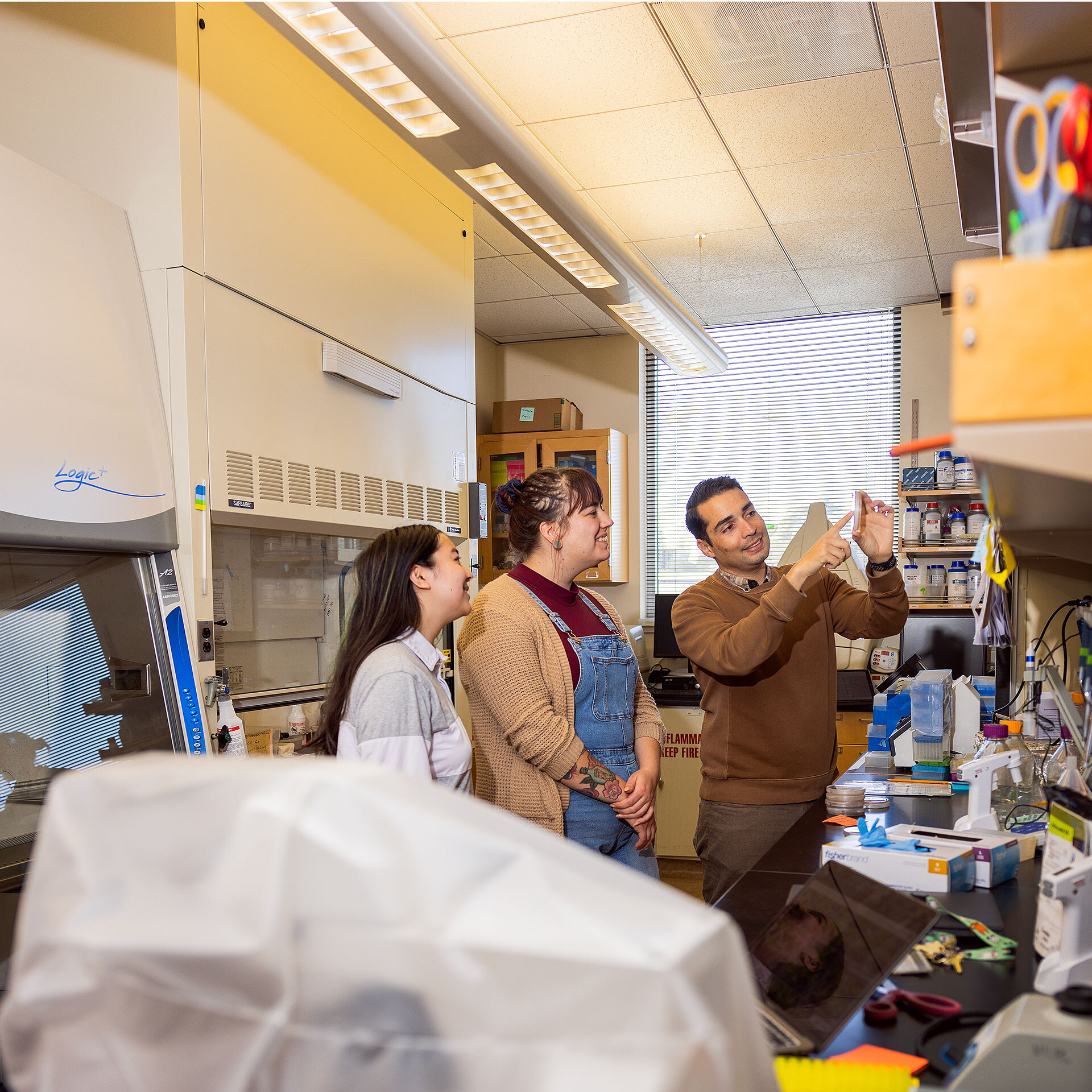 Two students and Professor JP at the lab