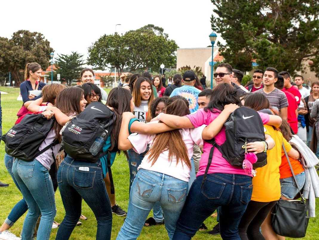 Group of students huddled in a circle