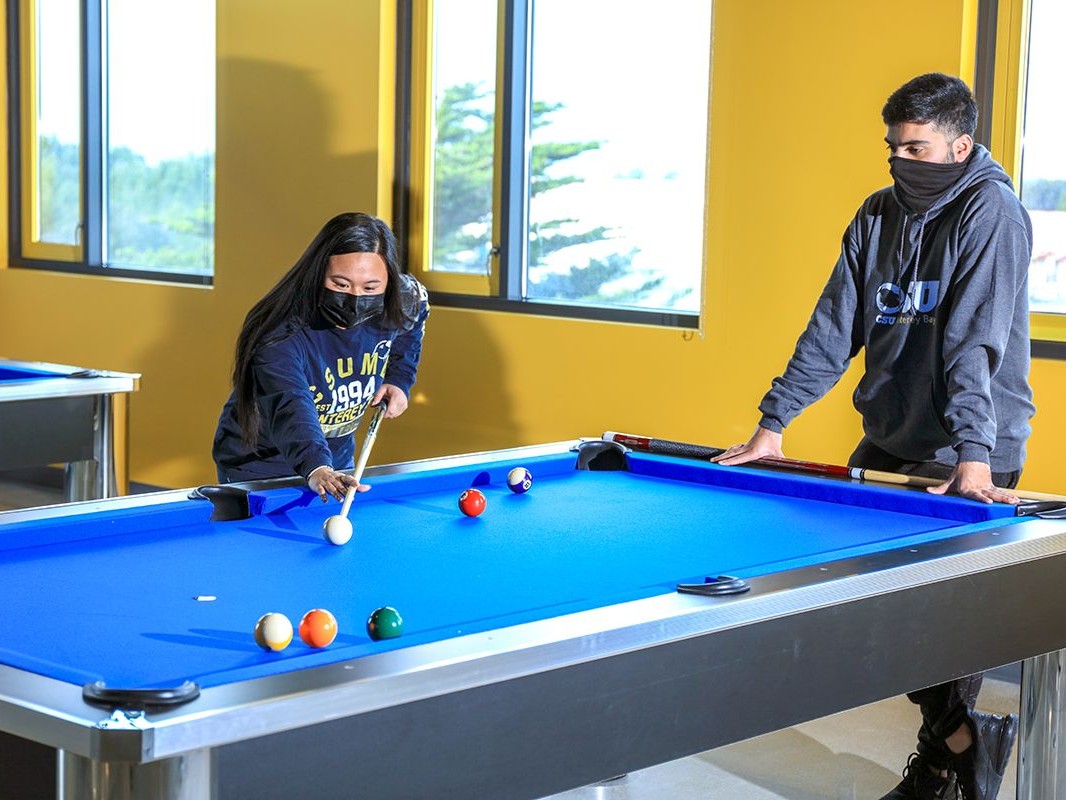 Two students playing pool