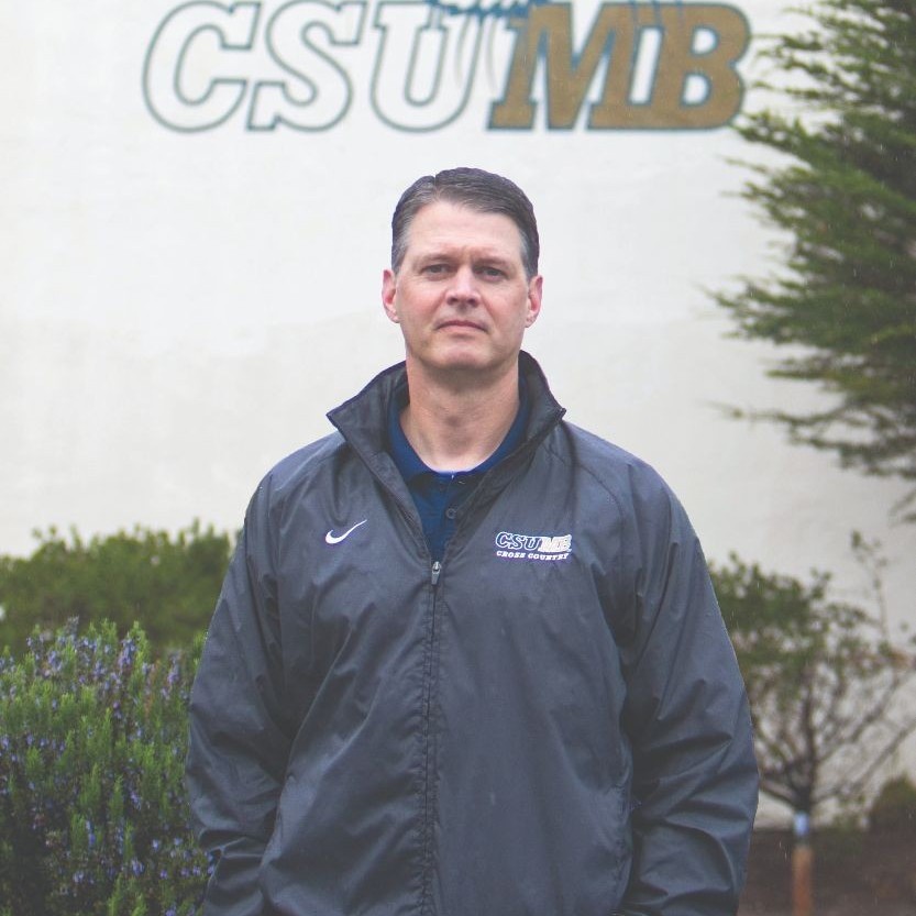 Herrod standing in front of the basketball gym