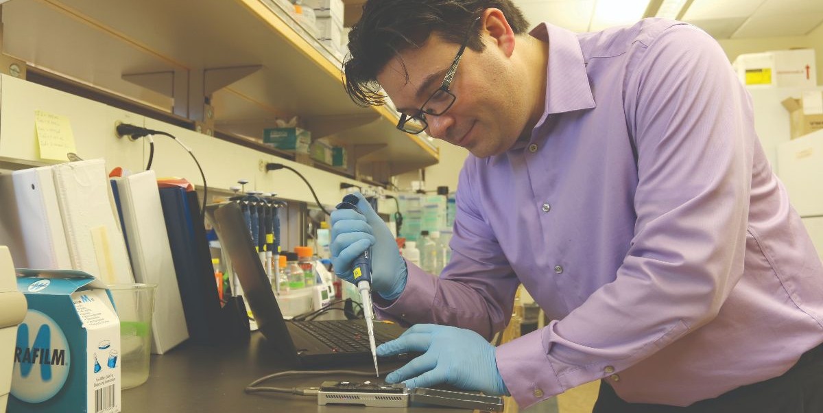 scientist using a gene sequencer