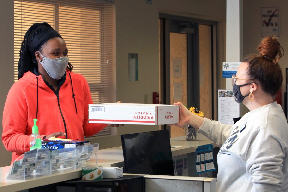 Kim McKinney, resident assistant, and Robyn DoCanto, coordinator of housing operations, are among the staff who remained on campus to serve students.