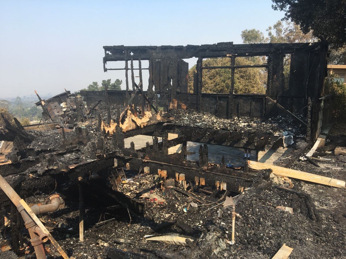 The gutted interior of the house, with an empty space in the middle that used to be the garage.