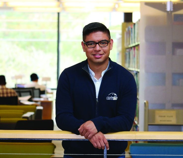 Student poses in library