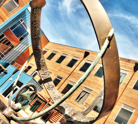 Sundial with campus housing in background