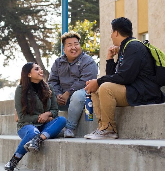 CSUMB Students sitting on concrete steps