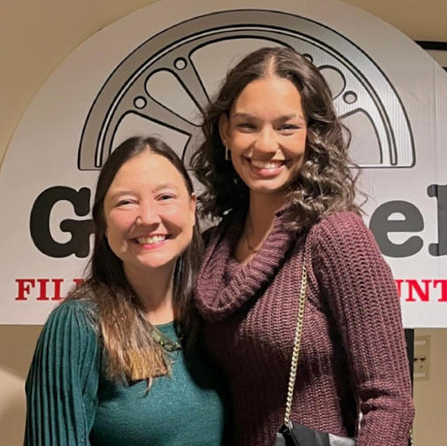 two women smile at camera, jasmyn is on the right