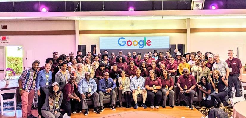 group photo of many students at a google backdrop presentation