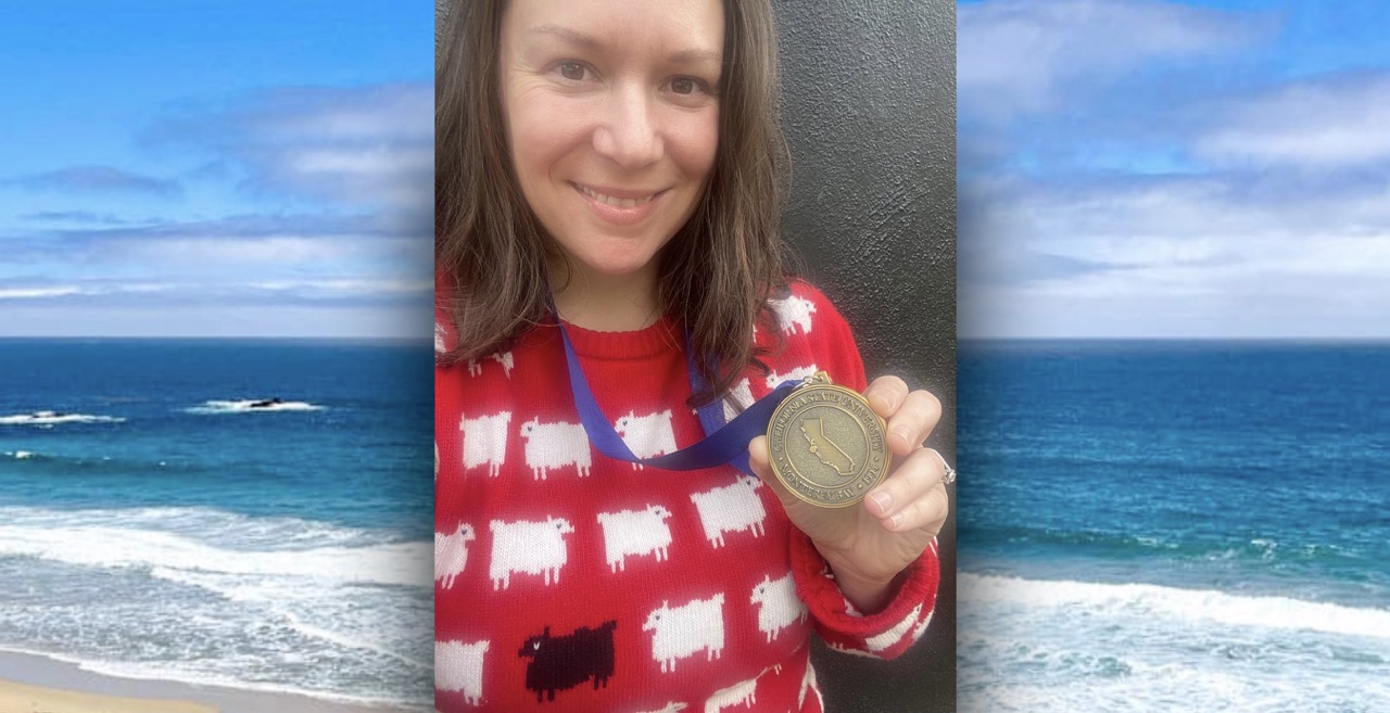 Dr. Burchett holding her President's Medal