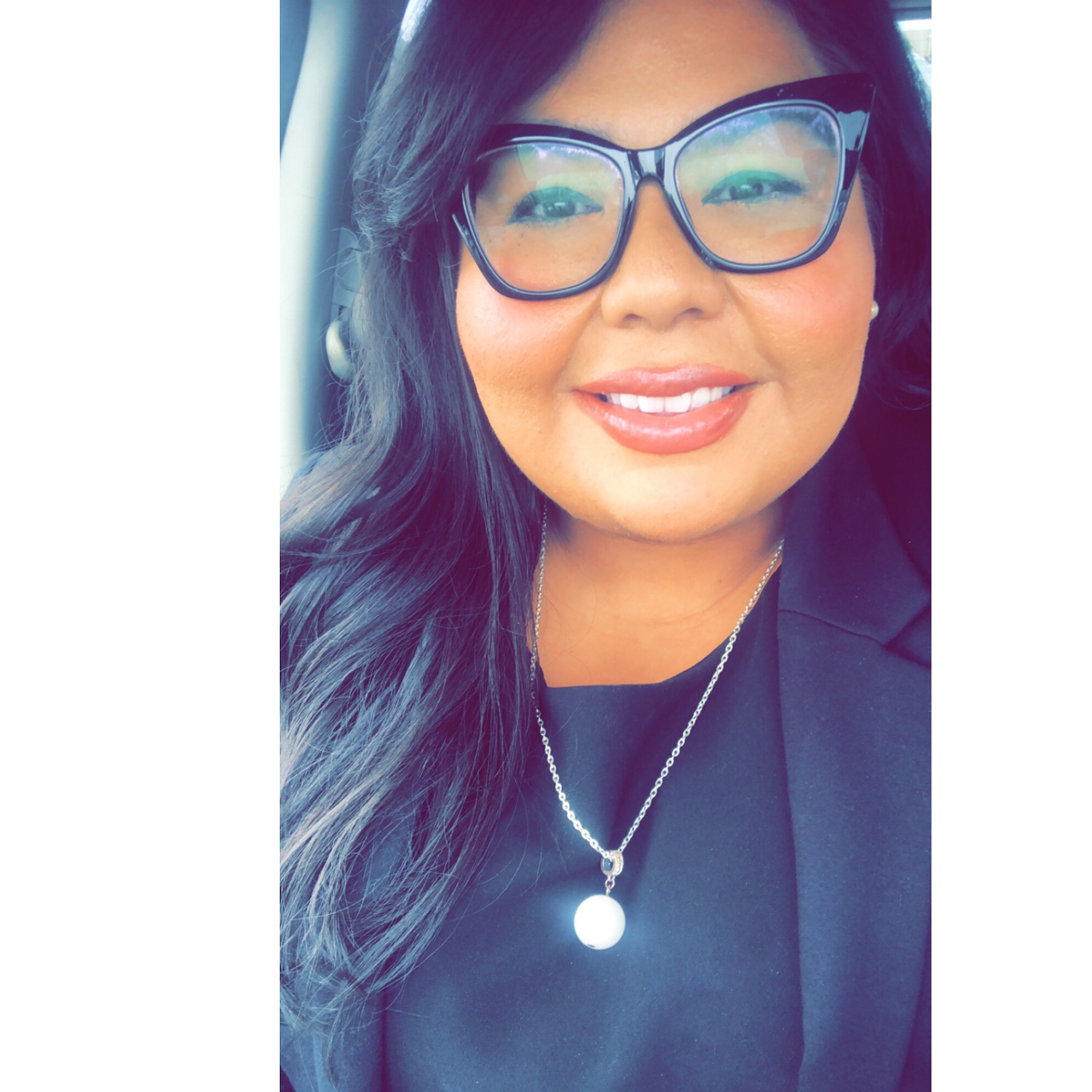 a headshot of Dr. Renee Penalver in a black jacket with glasses.