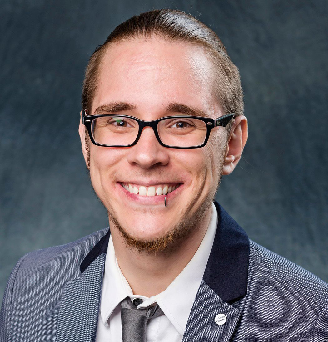 headshot of Kris Knisely wearing gray suit and necktie