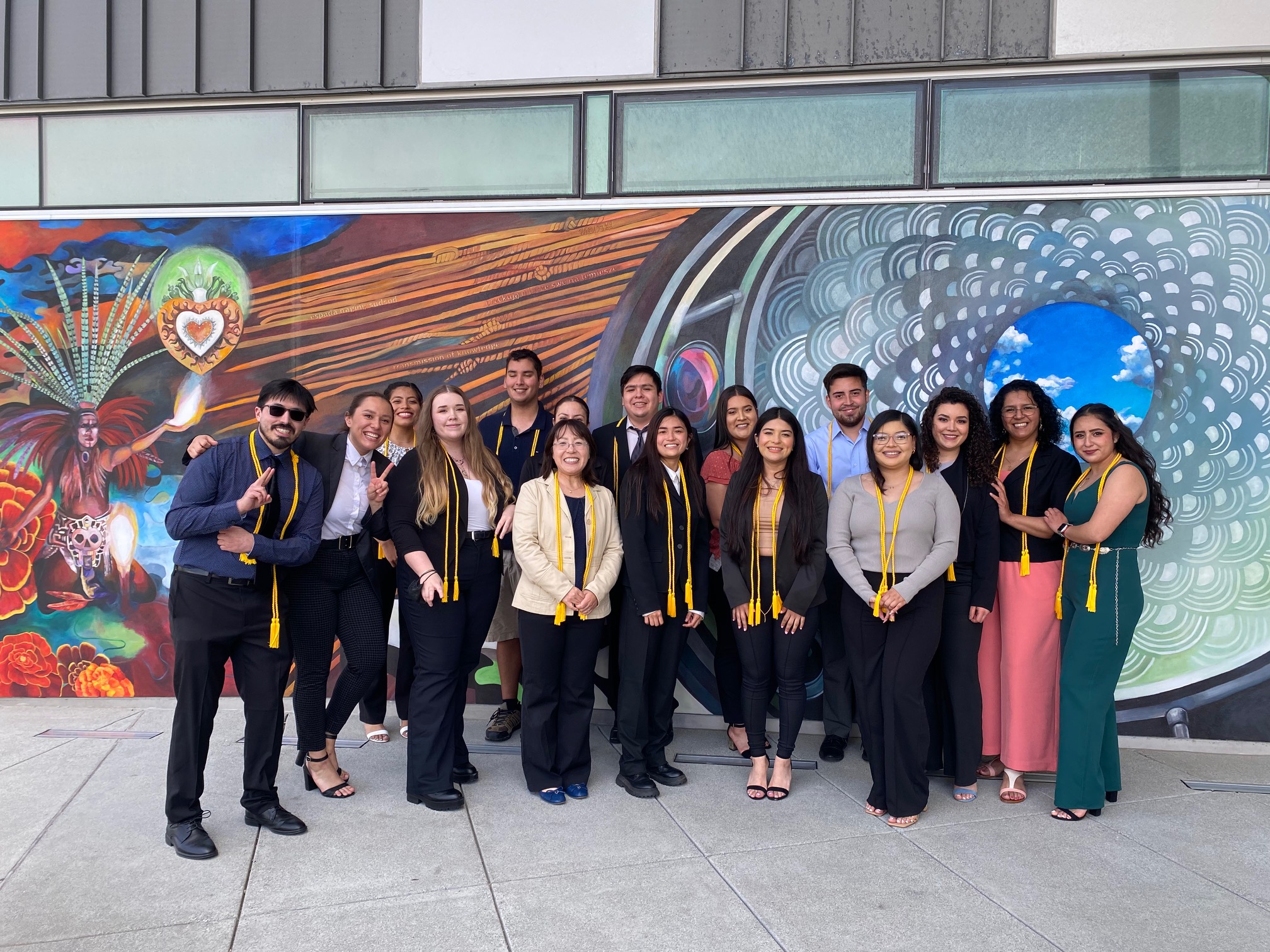 2022 Students gather in front of CAHSS mural