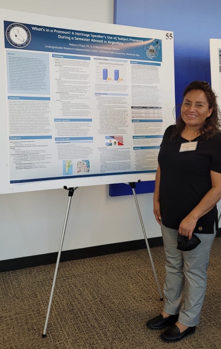 Myrna posing next to presentation poster