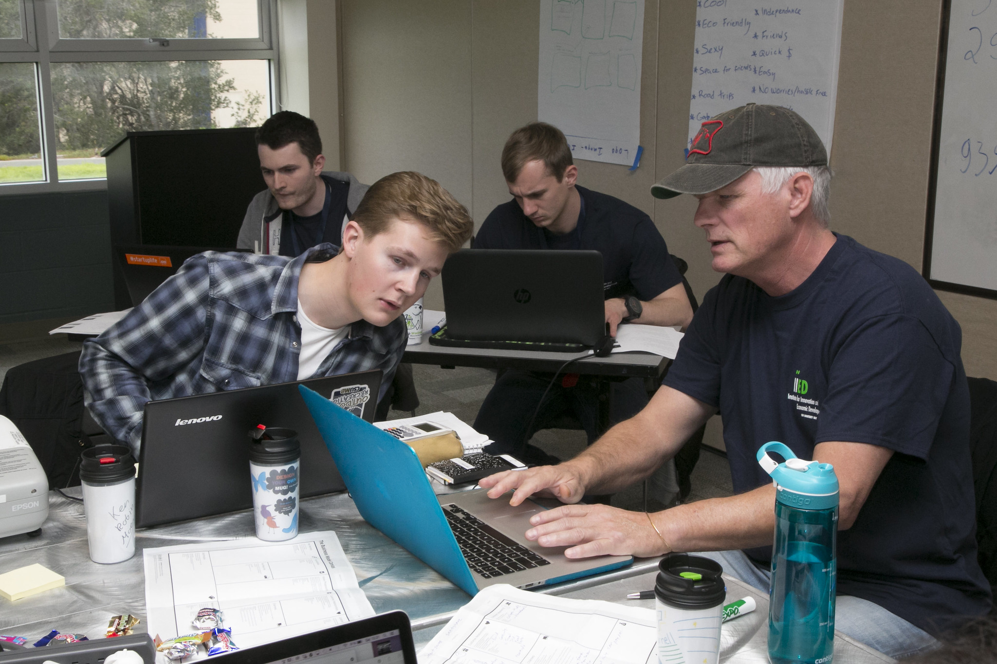 Four people on laptops