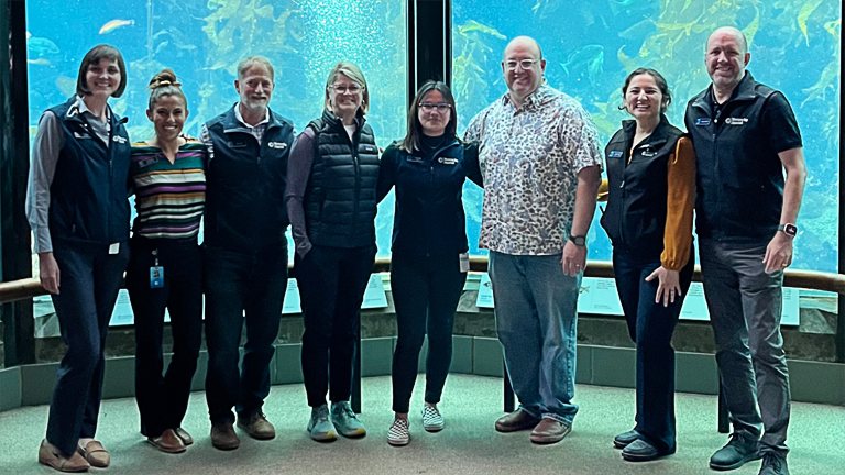 Alana Dale-Moore in group photo at Monterey Bay Aquarium