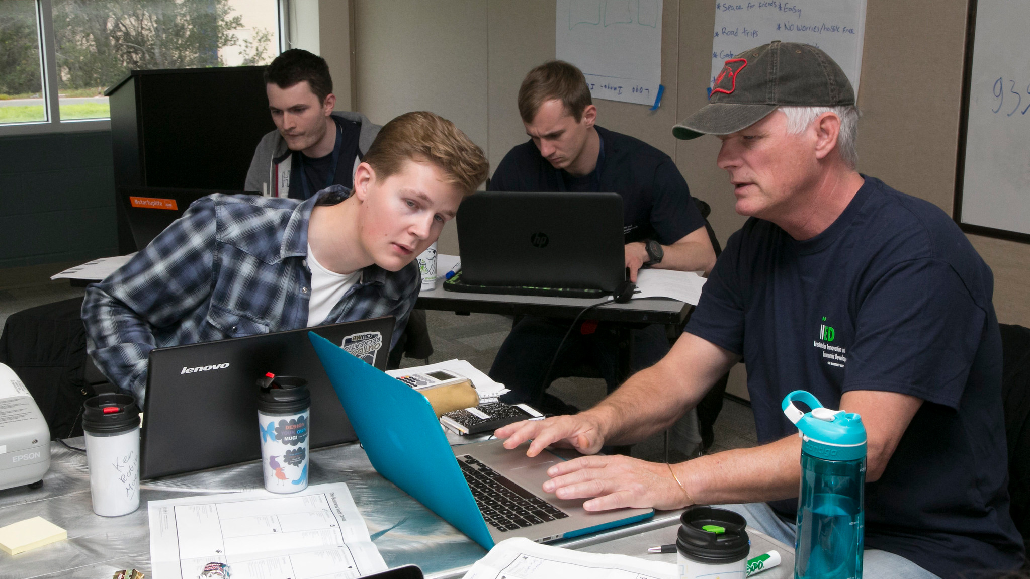 Four students around their personal computers