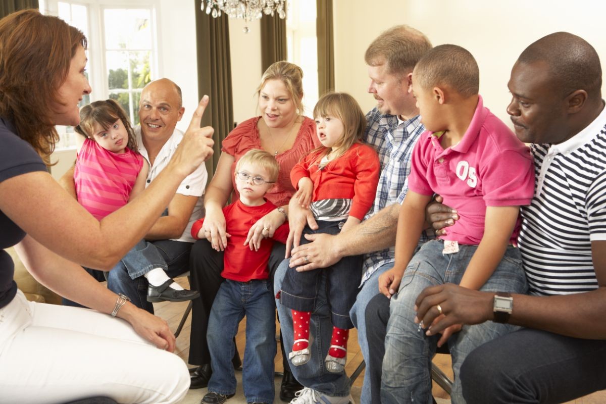 speech-language pathologist working with a group of families