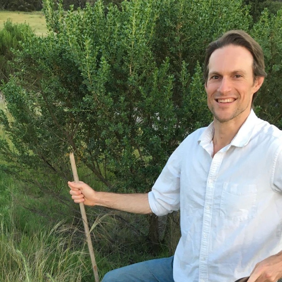 Student in front of shrub