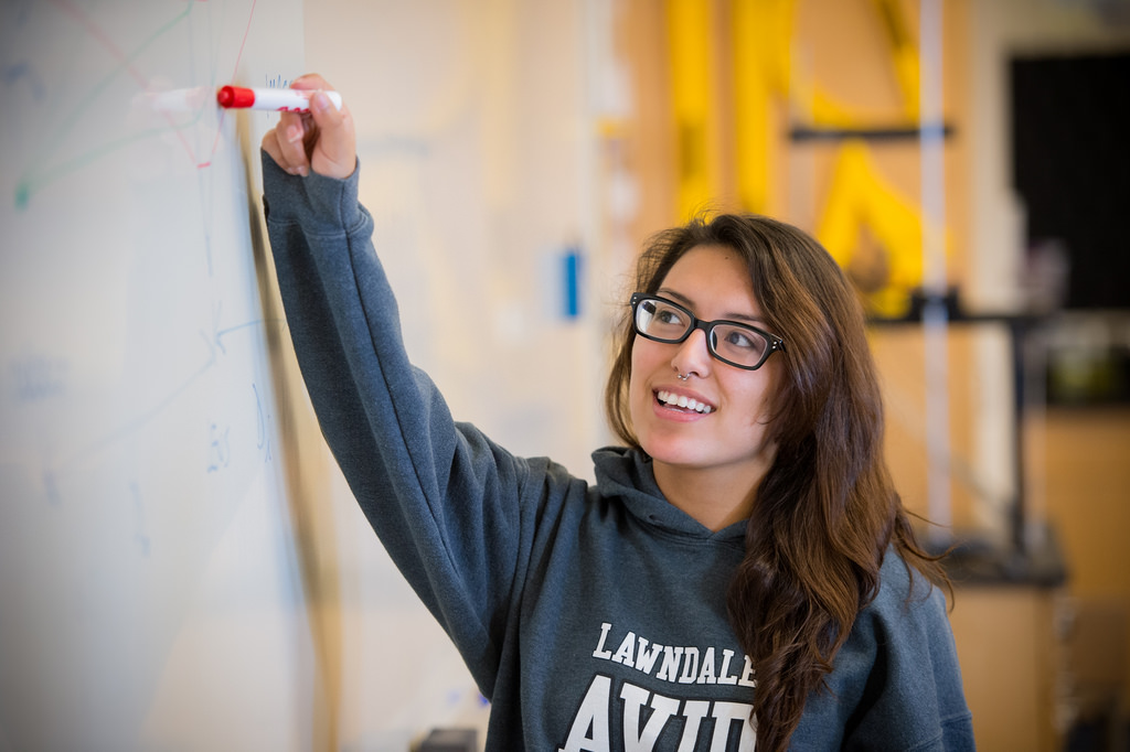 Student pointing to a whiteboard