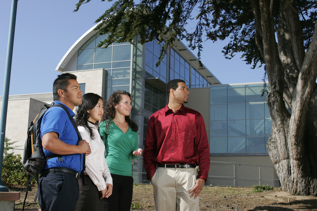 Four students in front of the Tanimura & Antle Family Memorial Library