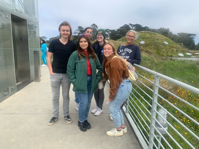 A group of students and Dr. Tori Derr smiling for the camera