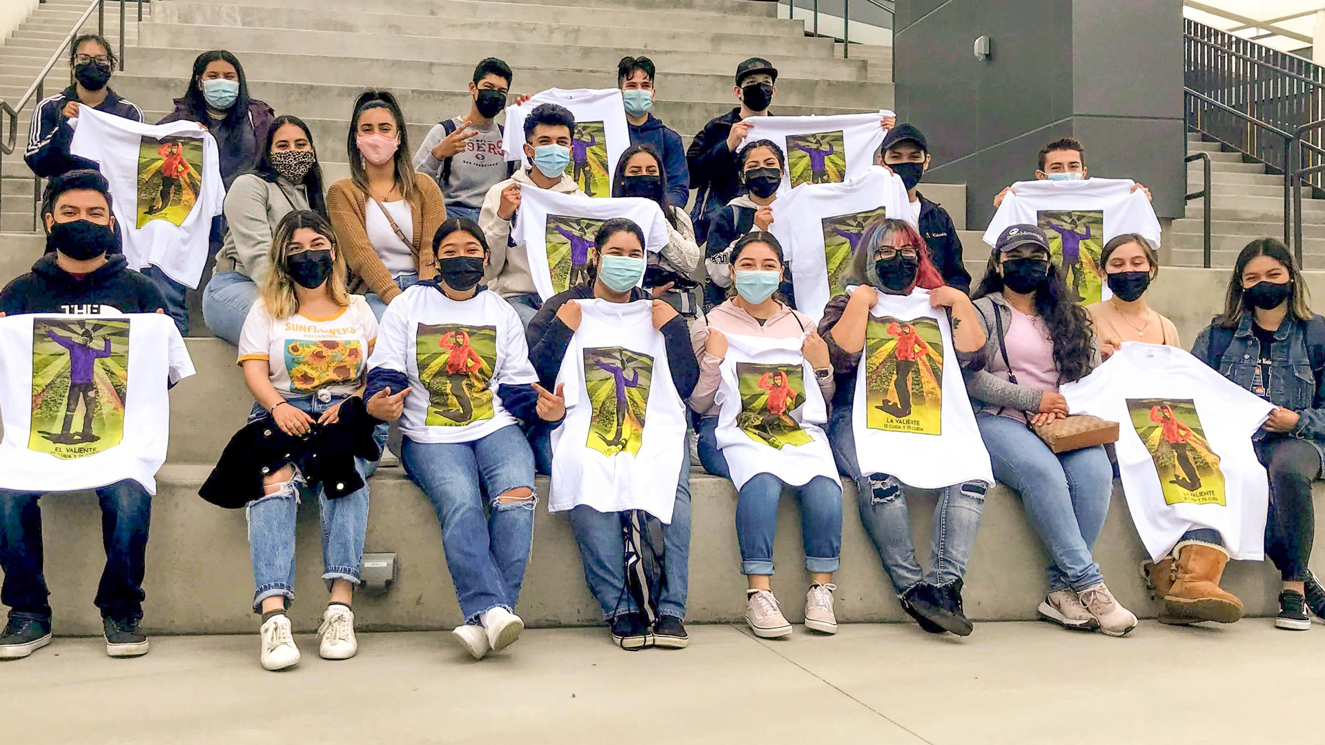 Group of students holding T-shirts