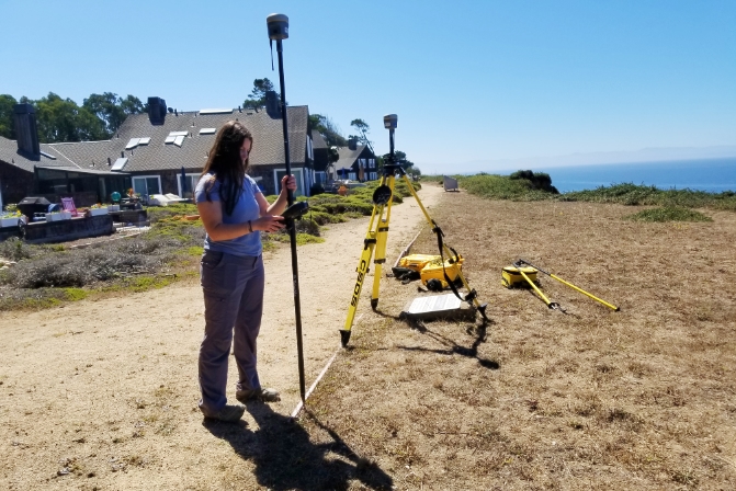 Student using survey equipment