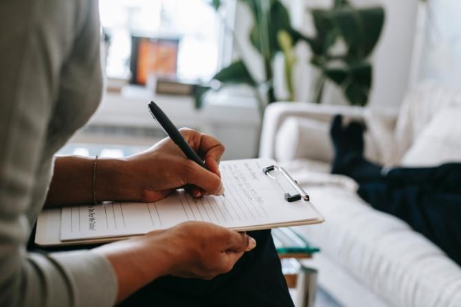 Person writing notes on a paper