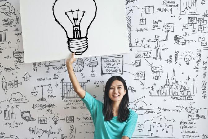 Girl holding lightbulb drawing over her head