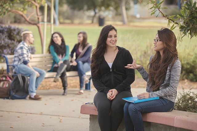 CSUMB students seated on bench