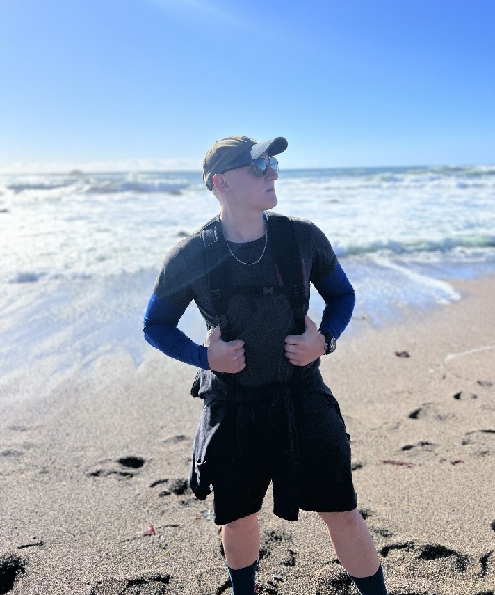 Student on beach with backpack