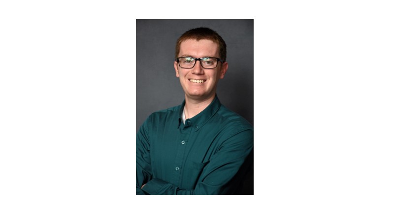 Student smiling wearing glasses