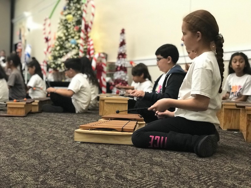 Christmas recital. Children playing their instruments.