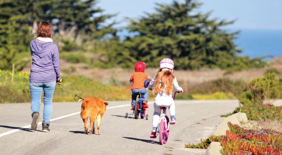 young family hiking on a trail