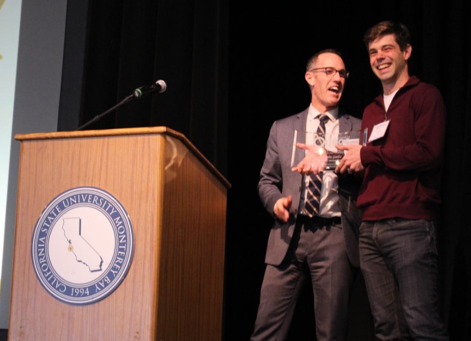 Dr. Andrew Lawson presents Dr. John Goeltz with the Mentor of the Year Award