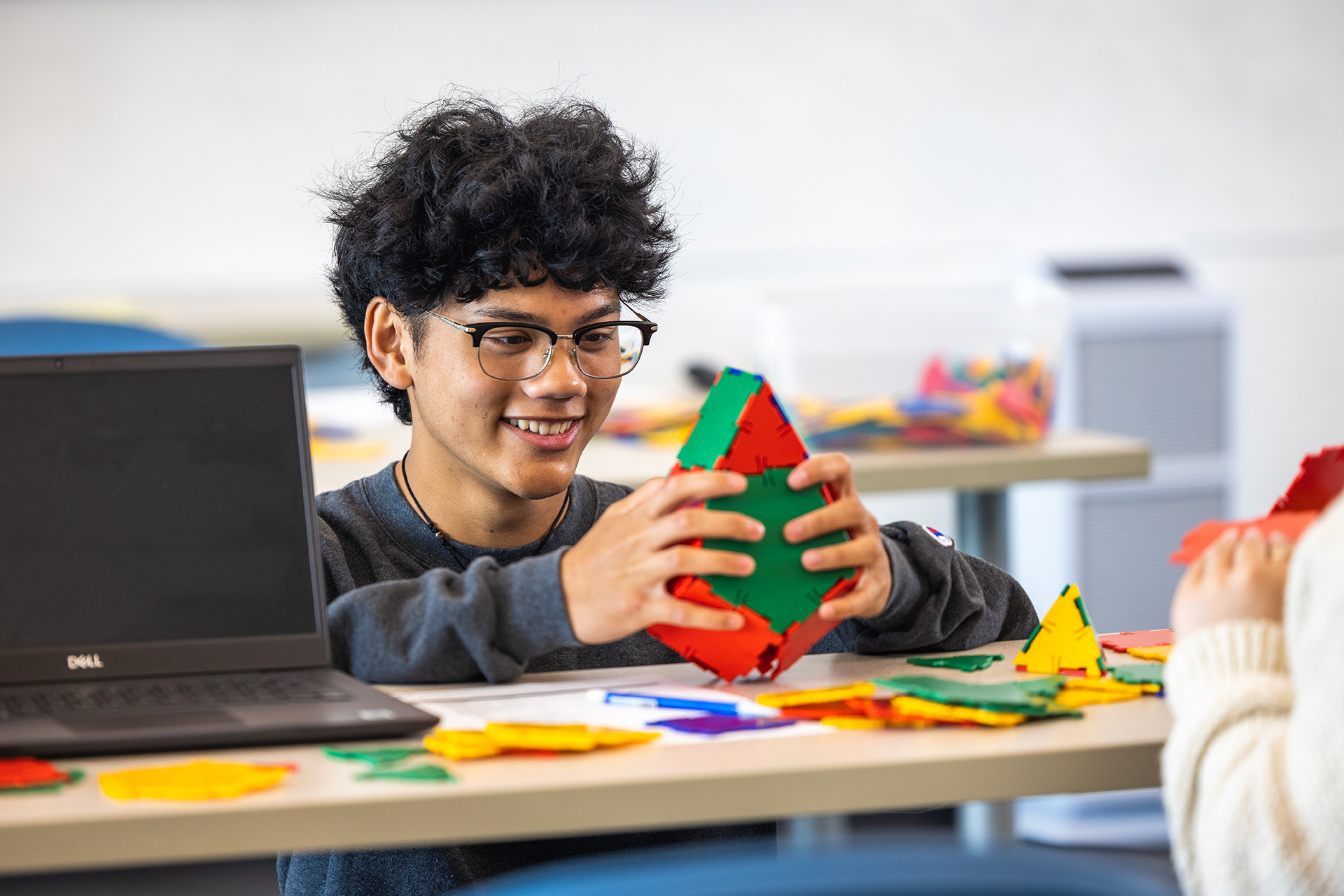 Male CSUMB Student building a puzzle