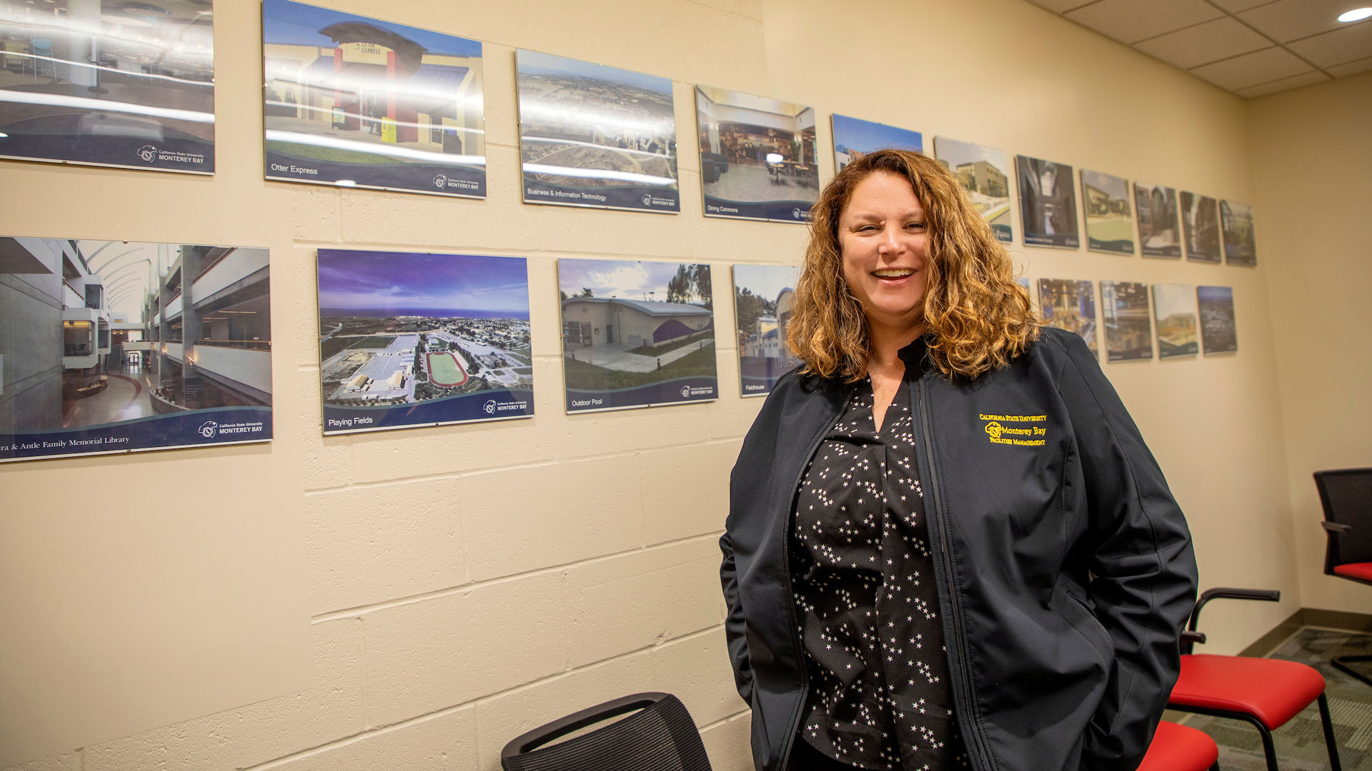 Construction manager standing in front of a wall of photos