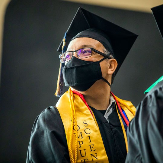 Photo: Class of 2020 graduate at the 2022 commencement