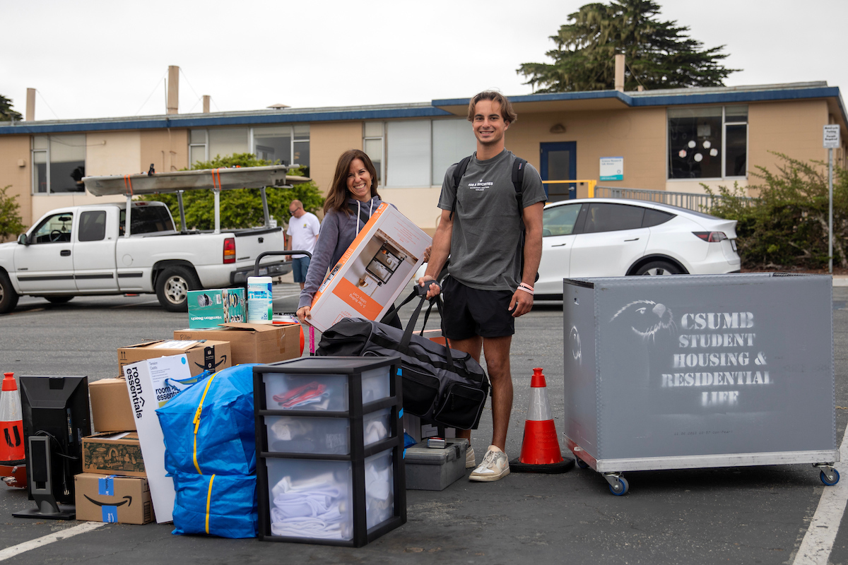 A student and his mother prepare to load up a university moving cart with dorm room gear on Friday, the first of two Move-in Days. | Photo by Brent Dundore-Arias (edited)