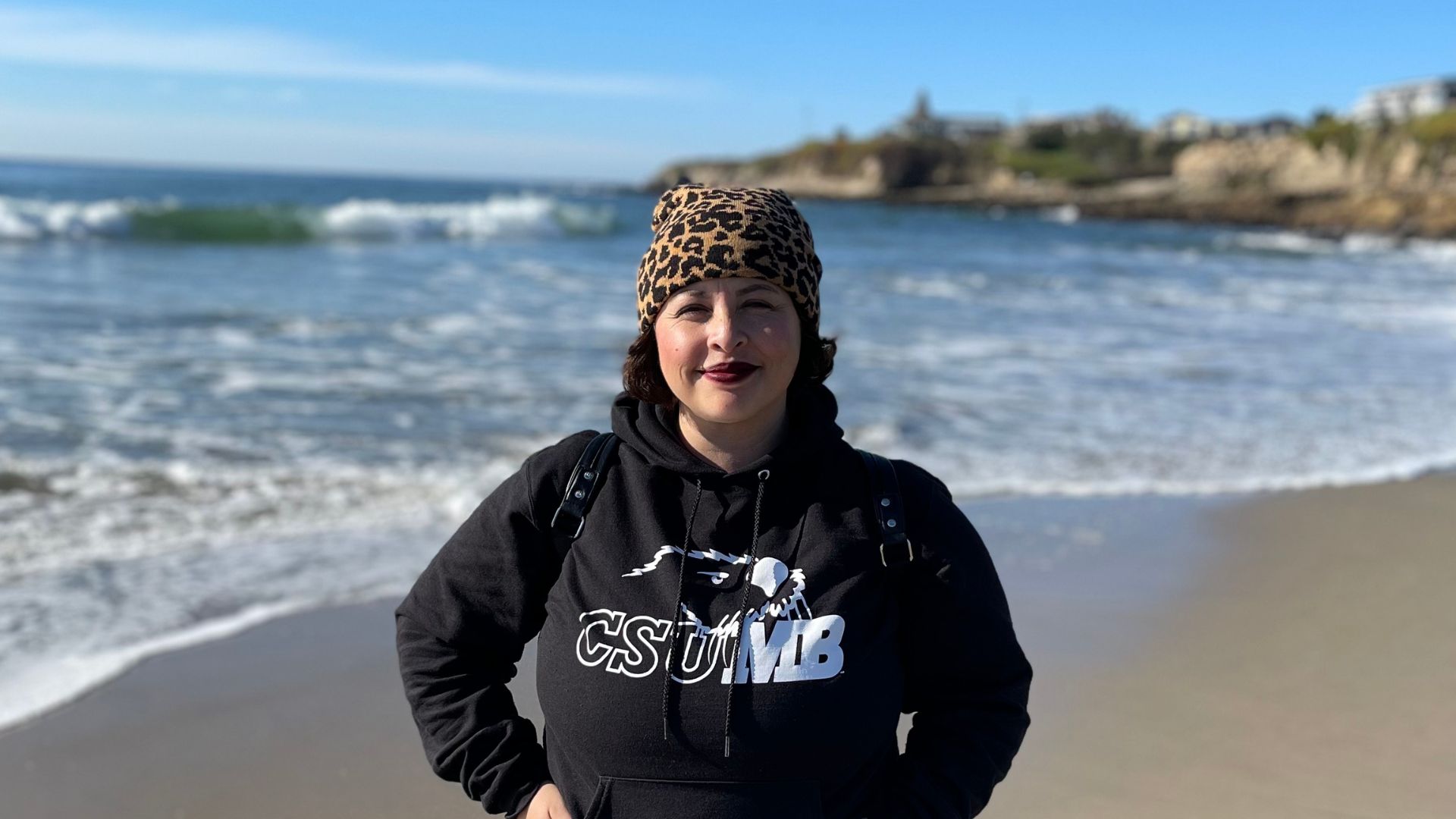 Student standing on the beach