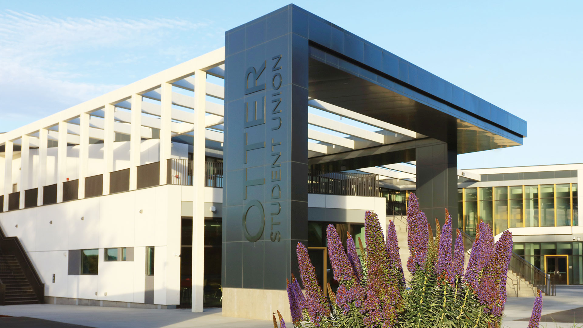 Photo: Exterior of the OSU building with purple flowers