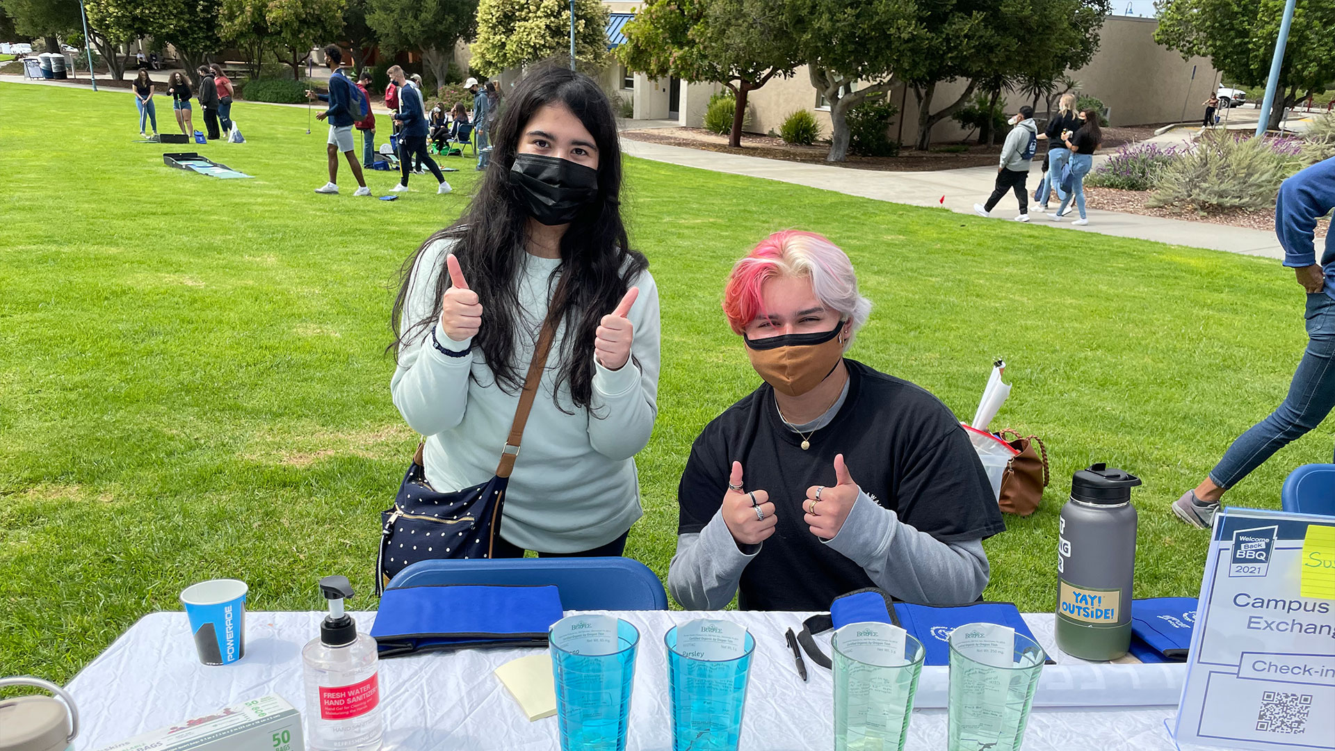 Two students at a table at the BBQ | Photo by Walter Ryce