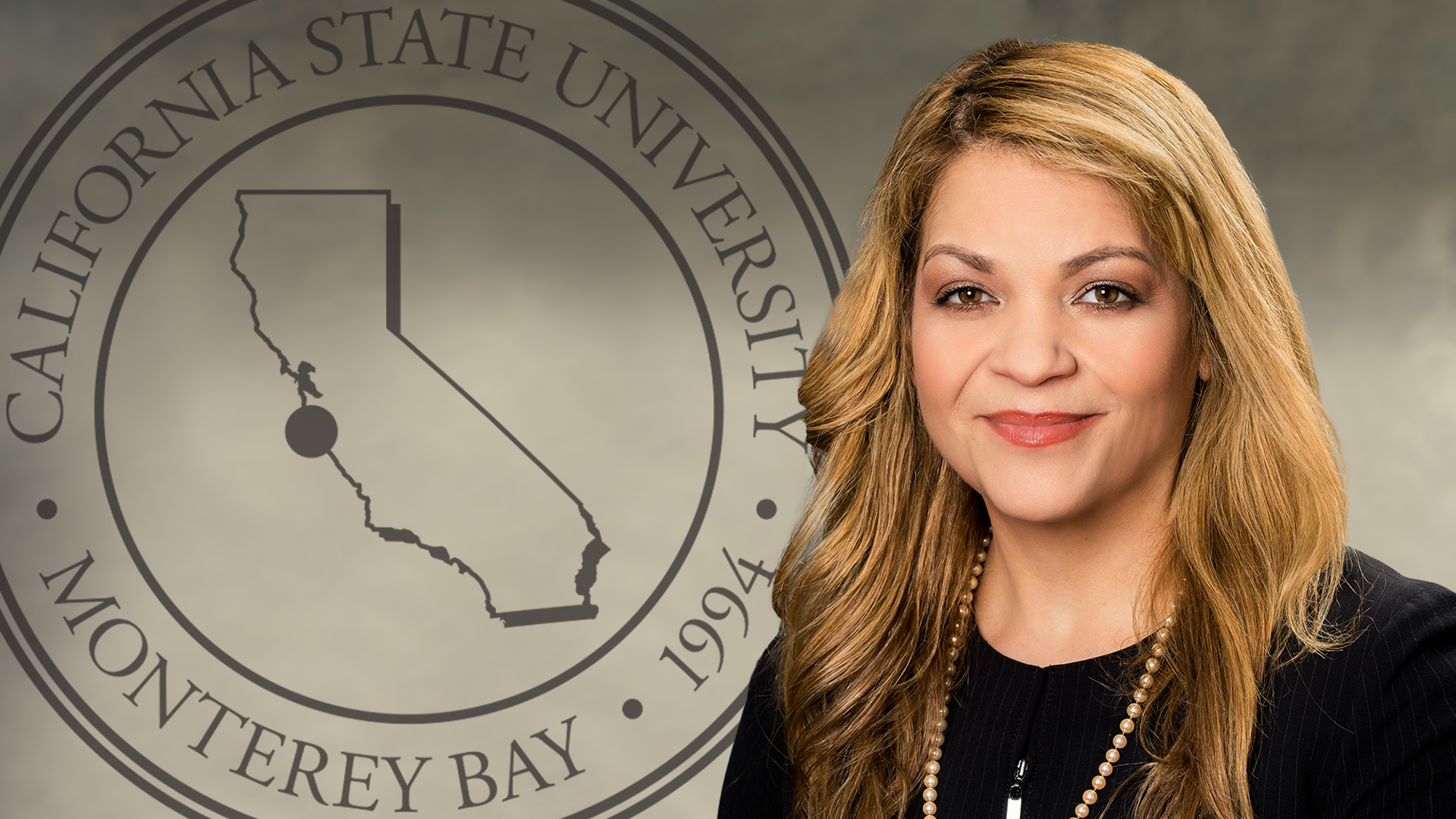 Portrait of Vanya Quinones with the CSUMB seal