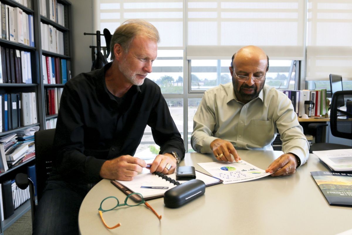 Brad Barbeau and Shyam Kamath discussing the institute's success.