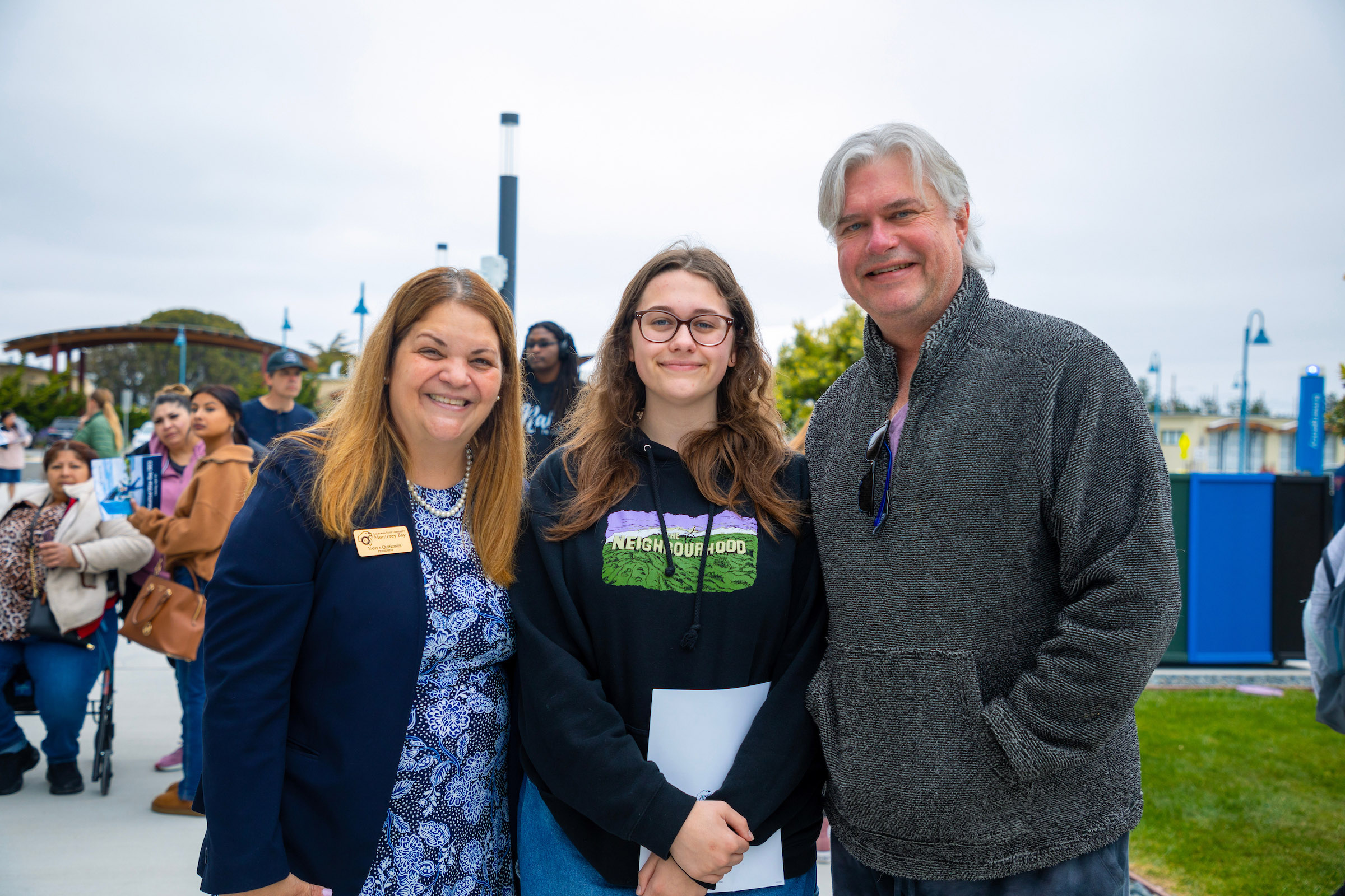 A future student with Vanya to her left and her father to her right.