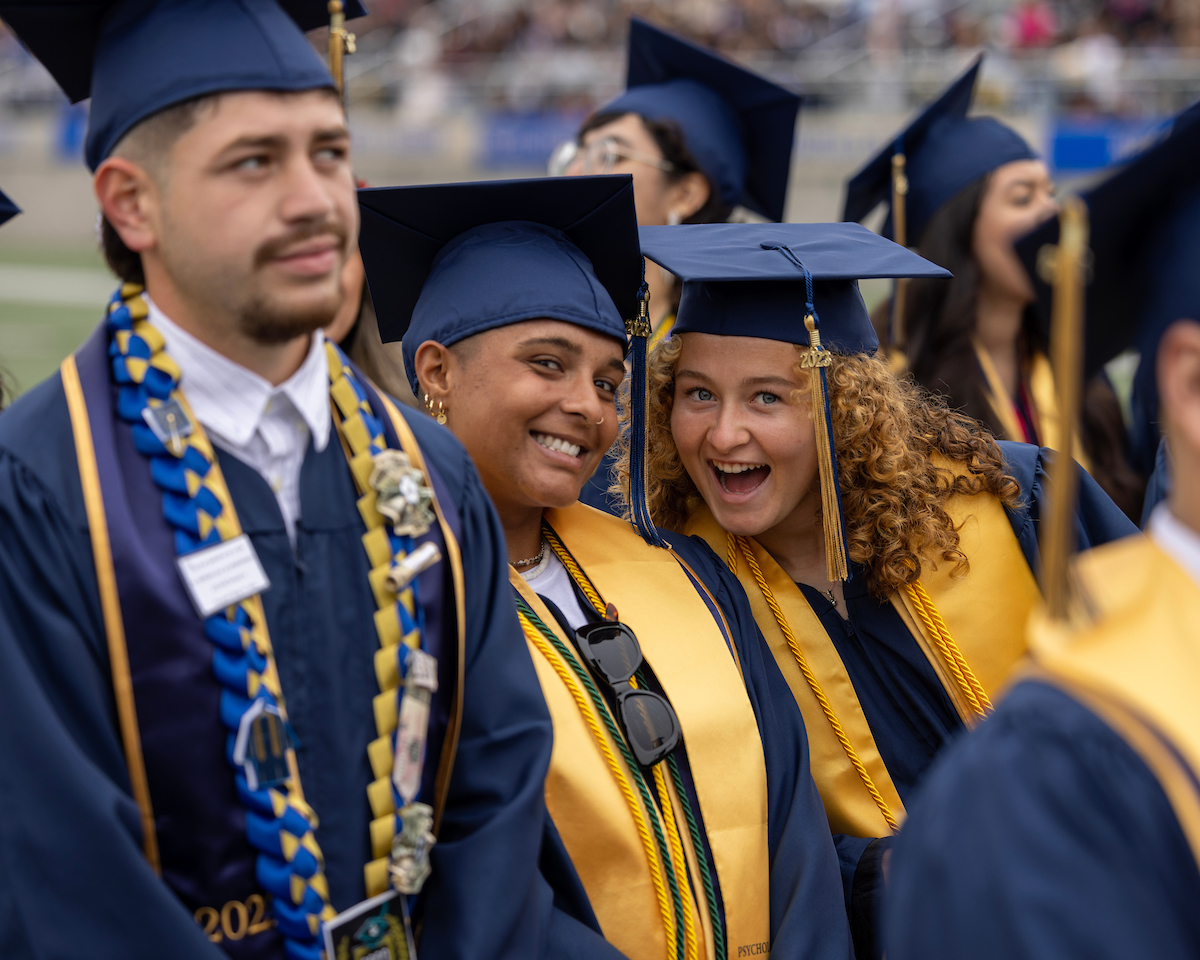 Students smiling next to each other at the CAHSS Convocation